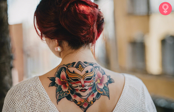 A Japanese good luck symbol tattoo on a woman’s upper back