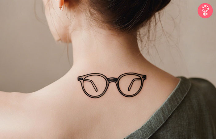 A woman sports a grandpa glasses tattoo on her back