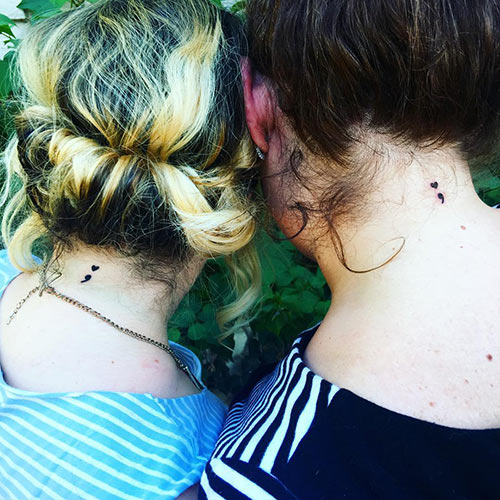 Semicolon tattoo design on the neck